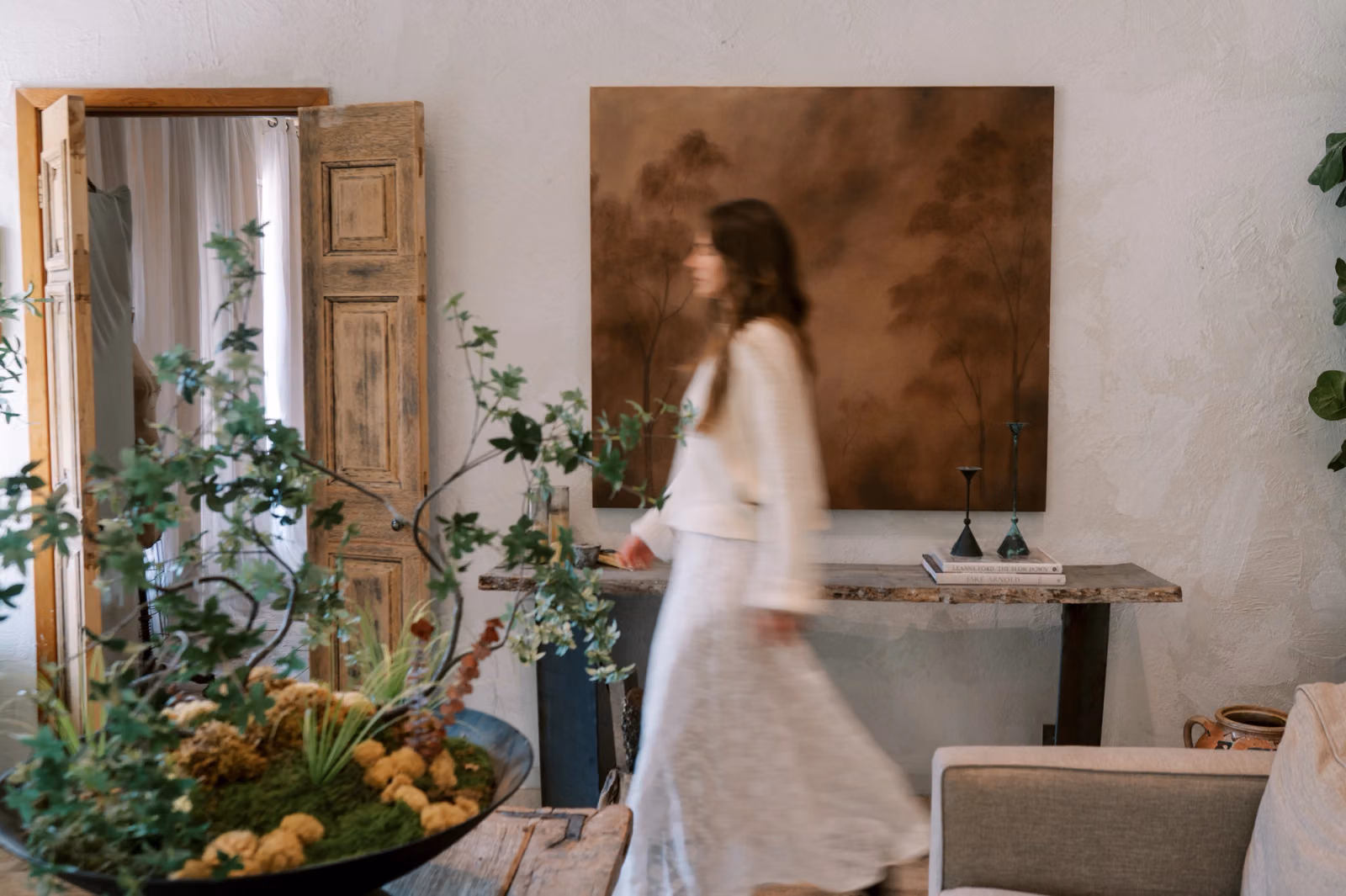 Walking in living room in front of painting